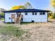 Inviting backyard featuring a wooden deck and well-maintained white siding at 7817 Mattie Mccoy Ln, Winston, GA 30187
