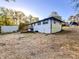 Backyard view of the house featuring a wooden deck with stairs, a storage shed, and ample yard space at 7817 Mattie Mccoy Ln, Winston, GA 30187