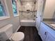 Bathroom features updated marble-look shower, tiled walls, modern vanity, and wood flooring at 7817 Mattie Mccoy Ln, Winston, GA 30187
