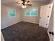 Well-lit bedroom with two windows, ceiling fan, neutral paint and carpet at 7817 Mattie Mccoy Ln, Winston, GA 30187