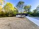 Single story brick home on a sprawling lot with a long driveway and attached carport at 7817 Mattie Mccoy Ln, Winston, GA 30187