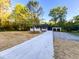 Ranch-style home with a long concrete driveway leading to a white-painted brick home with an attached carport at 7817 Mattie Mccoy Ln, Winston, GA 30187