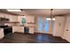 Modern kitchen with white cabinets, granite counters, and stainless steel appliances at 7817 Mattie Mccoy Ln, Winston, GA 30187