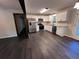 Modern kitchen featuring stainless steel appliances, white cabinets, and hardwood floors at 7817 Mattie Mccoy Ln, Winston, GA 30187