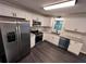 Updated kitchen with stainless steel appliances, granite countertops, and white cabinets at 7817 Mattie Mccoy Ln, Winston, GA 30187