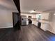 Modern kitchen featuring stainless steel appliances, white cabinets, and hardwood floors at 7817 Mattie Mccoy Ln, Winston, GA 30187