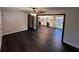 Bright living room showcasing dark floors and a view of the modern kitchen at 7817 Mattie Mccoy Ln, Winston, GA 30187