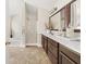 Bathroom featuring a shower with glass door, soaking tub and double sink vanity at 1165 Evergreen Oak Way, Dacula, GA 30019