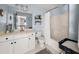 Powder blue bathroom with cream vanity, white toilet and tub/shower with white shower curtain at 1165 Evergreen Oak Way, Dacula, GA 30019