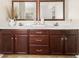 Bathroom features a double sink vanity with dark wood cabinets and a tiled floor at 1165 Evergreen Oak Way, Dacula, GA 30019