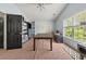 Bedroom or flex space with desk, shelves, and large windows for natural light at 1165 Evergreen Oak Way, Dacula, GA 30019