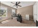 Bedroom with dark office desk and two windows. Ceiling fan and neutral walls and carpet at 1165 Evergreen Oak Way, Dacula, GA 30019