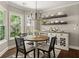 Cozy breakfast nook with bright windows, modern chandelier, and charming decor at 1165 Evergreen Oak Way, Dacula, GA 30019