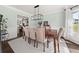 Formal dining room with elegant decor, a large table, and views to the kitchen at 1165 Evergreen Oak Way, Dacula, GA 30019