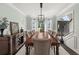 Bright and spacious dining room with large windows, elegant lighting, and a view to the entry foyer at 1165 Evergreen Oak Way, Dacula, GA 30019