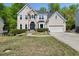 Beautiful two-story home with stone accents, a well-manicured lawn, and an attached two-car garage at 1165 Evergreen Oak Way, Dacula, GA 30019