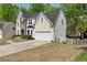 Two-story home showcasing a brick-and-siding facade with a two-car garage at 1165 Evergreen Oak Way, Dacula, GA 30019
