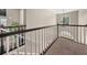 Upstairs hallway landing with carpeted floors and wrought iron and white painted spindles at 1165 Evergreen Oak Way, Dacula, GA 30019