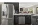 Spacious kitchen with stainless steel appliances, dishwasher, and access to the living room at 1165 Evergreen Oak Way, Dacula, GA 30019