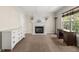 Living room features neutral walls, carpet and mantle and hearth fireplace at 1165 Evergreen Oak Way, Dacula, GA 30019