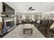Open living room with fireplace, ceiling fan, and large windows at 1165 Evergreen Oak Way, Dacula, GA 30019