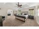 Main bedroom suite with fireplace and sitting area. Tray ceiling and ceiling fan at 1165 Evergreen Oak Way, Dacula, GA 30019