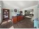 Well-lit home office with dark hardwood floors, a large desk, and an adjacent living area at 1165 Evergreen Oak Way, Dacula, GA 30019