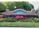Community entrance sign featuring lush landscaping and stone pillars at 1165 Evergreen Oak Way, Dacula, GA 30019