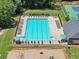 Aerial view of the community pool, with lounge chairs and manicured green space at 1165 Evergreen Oak Way, Dacula, GA 30019
