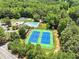 Aerial view of community tennis courts surrounded by mature trees at 1165 Evergreen Oak Way, Dacula, GA 30019
