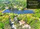 Picturesque aerial view of a property with a lake, surrounded by lush greenery and mature trees at 1531 Cooper Lake Se Rd, Smyrna, GA 30082