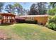 View of brick home with a lush green lawn, a wooden gazebo, and mature landscaping at 1531 Cooper Lake Se Rd, Smyrna, GA 30082
