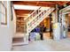 Unfinished basement features stairs with white railing and a water heater at 1531 Cooper Lake Se Rd, Smyrna, GA 30082
