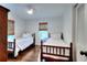 Charming bedroom featuring two twin beds, hardwood floors, and natural light at 1531 Cooper Lake Se Rd, Smyrna, GA 30082