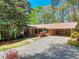Charming single-story home with a well-manicured lawn and mature trees providing shade at 1531 Cooper Lake Se Rd, Smyrna, GA 30082