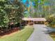Charming single-story home with a well-manicured lawn and mature trees providing shade at 1531 Cooper Lake Se Rd, Smyrna, GA 30082