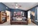 Den features a leather sofa, blue walls, and decorative items at 1531 Cooper Lake Se Rd, Smyrna, GA 30082