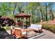 Inviting patio area with comfortable seating, a gazebo, and lush landscaping creating a relaxing outdoor space at 1531 Cooper Lake Se Rd, Smyrna, GA 30082