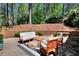 Cozy outdoor patio with seating area and brick retaining wall at 1531 Cooper Lake Se Rd, Smyrna, GA 30082