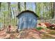 Outdoor storage shed surrounded by woods on a property with a lake view at 1531 Cooper Lake Se Rd, Smyrna, GA 30082