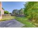Large, grassy backyard with a patio area and a wooden privacy fence, perfect for outdoor activities at 1691 Scenic Pines Dr, Lawrenceville, GA 30044