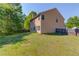 The home's grassy backyard with a wooden fence, offering a great area for recreation and relaxation at 1691 Scenic Pines Dr, Lawrenceville, GA 30044
