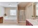 Primary bathroom with a soaking tub, shower, vanity and window at 1691 Scenic Pines Dr, Lawrenceville, GA 30044