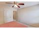 Bedroom with neutral walls, carpet, a ceiling fan, and a doorway to the hallway at 1691 Scenic Pines Dr, Lawrenceville, GA 30044
