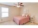Bedroom with light walls, carpet, a ceiling fan, and a sunlit window at 1691 Scenic Pines Dr, Lawrenceville, GA 30044