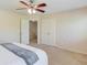 Bedroom featuring a ceiling fan, neutral paint, carpet, and access to a large closet at 1691 Scenic Pines Dr, Lawrenceville, GA 30044