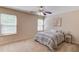 Bedroom featuring two sunlit windows, neutral walls, carpet, and a ceiling fan at 1691 Scenic Pines Dr, Lawrenceville, GA 30044