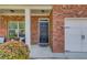 Welcoming front porch with brick facade and decorative door, leading to a charming home at 1691 Scenic Pines Dr, Lawrenceville, GA 30044