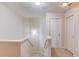 Upstairs hallway landing with neutral walls and carpeted floors at 1691 Scenic Pines Dr, Lawrenceville, GA 30044