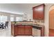 Modern kitchen with stainless steel dishwasher, granite countertops and breakfast bar overlooking the living spaces at 1691 Scenic Pines Dr, Lawrenceville, GA 30044
